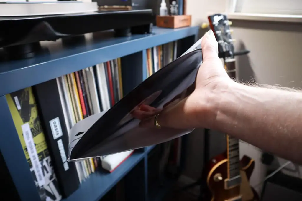 Pull the record from it's sleeve without touch the groove
